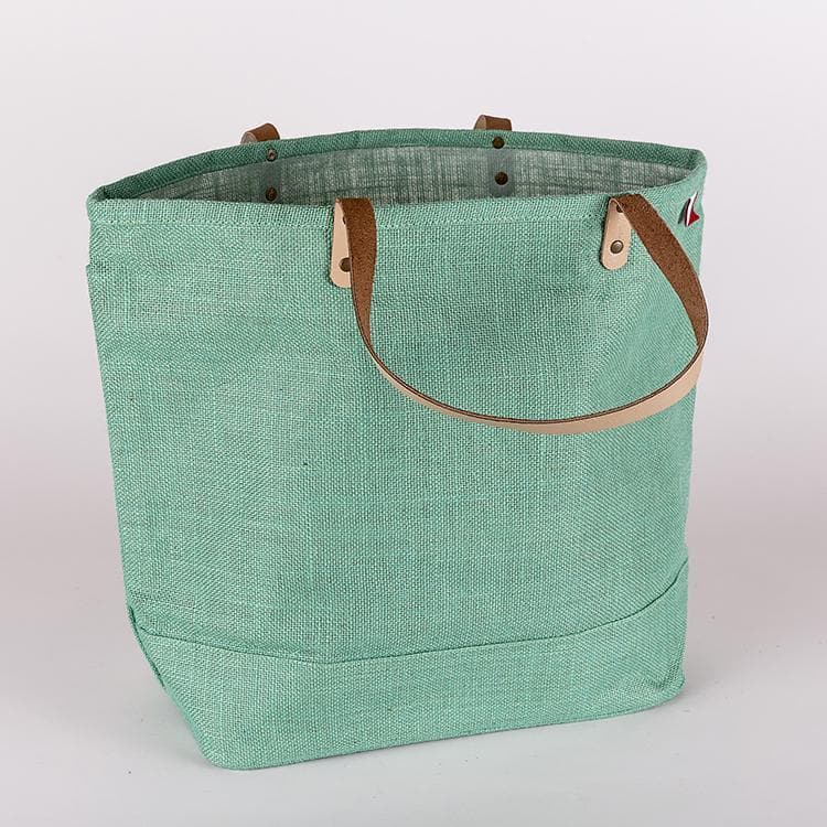 "Big Jute Bag from ShoreBags. Made with all-natural jute that's vegetable-dyed in bright colors, this bag has leather handles and a laminated interior."