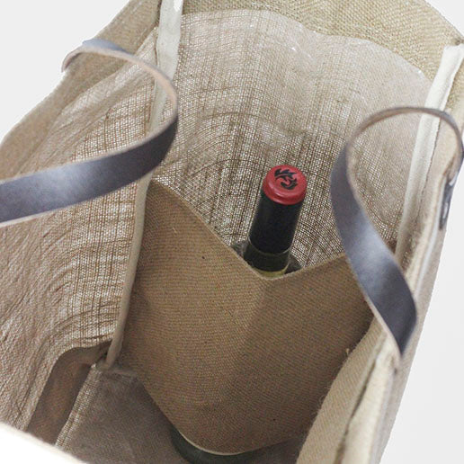 Close up picture of the Bazaar Tote from ShoreBags made from all-natural jute with natural canvas trim and leather handles. This bag has a laminated interior and is made from sustainable materials. 
